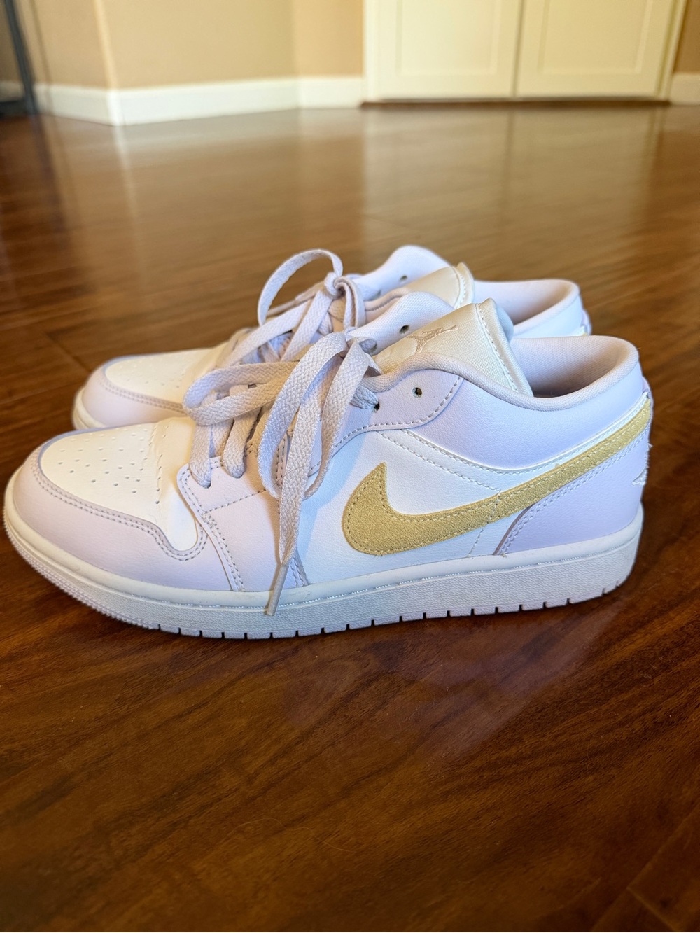 Nike Kids White Sneakers with Gold Swoosh Accent
